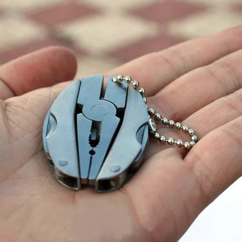 Keychain multi-tool folded in the palm of a hand