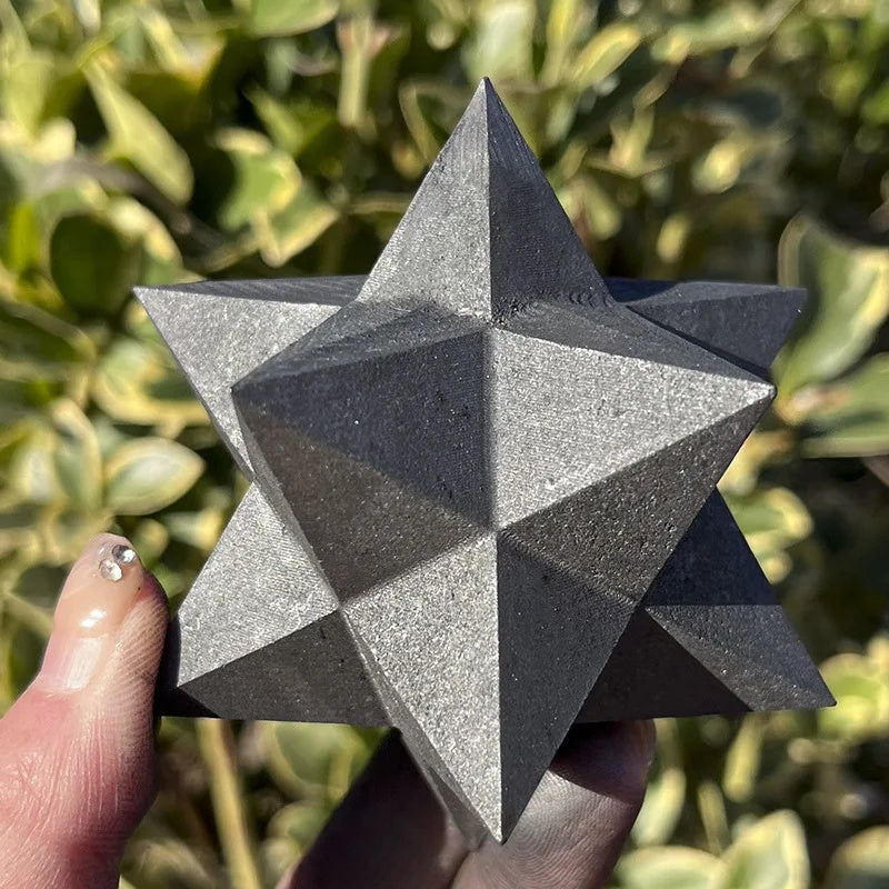 Shungite star held in hand